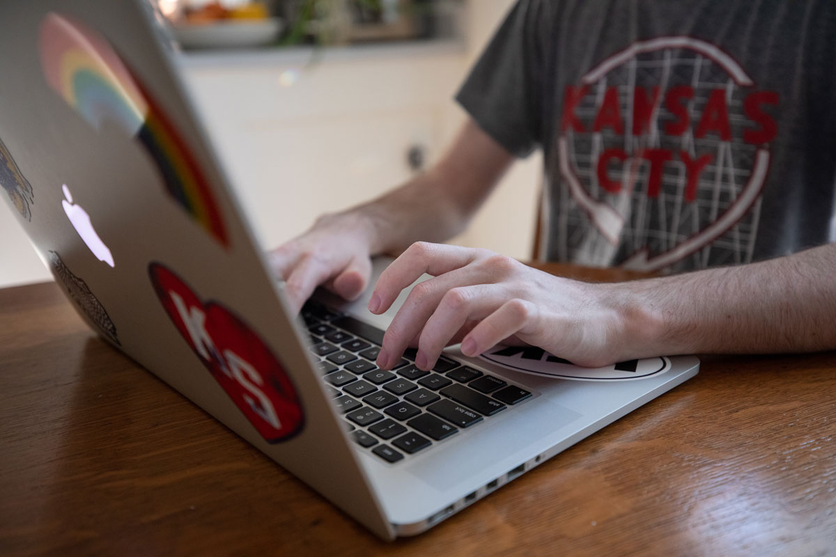 Person types on laptop